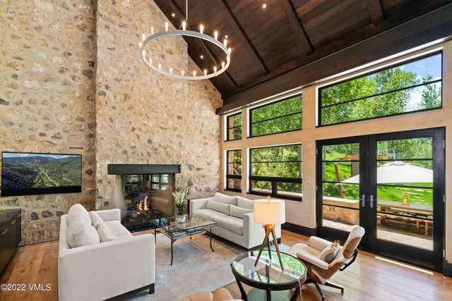 a living room with fireplace furniture and a floor to ceiling window