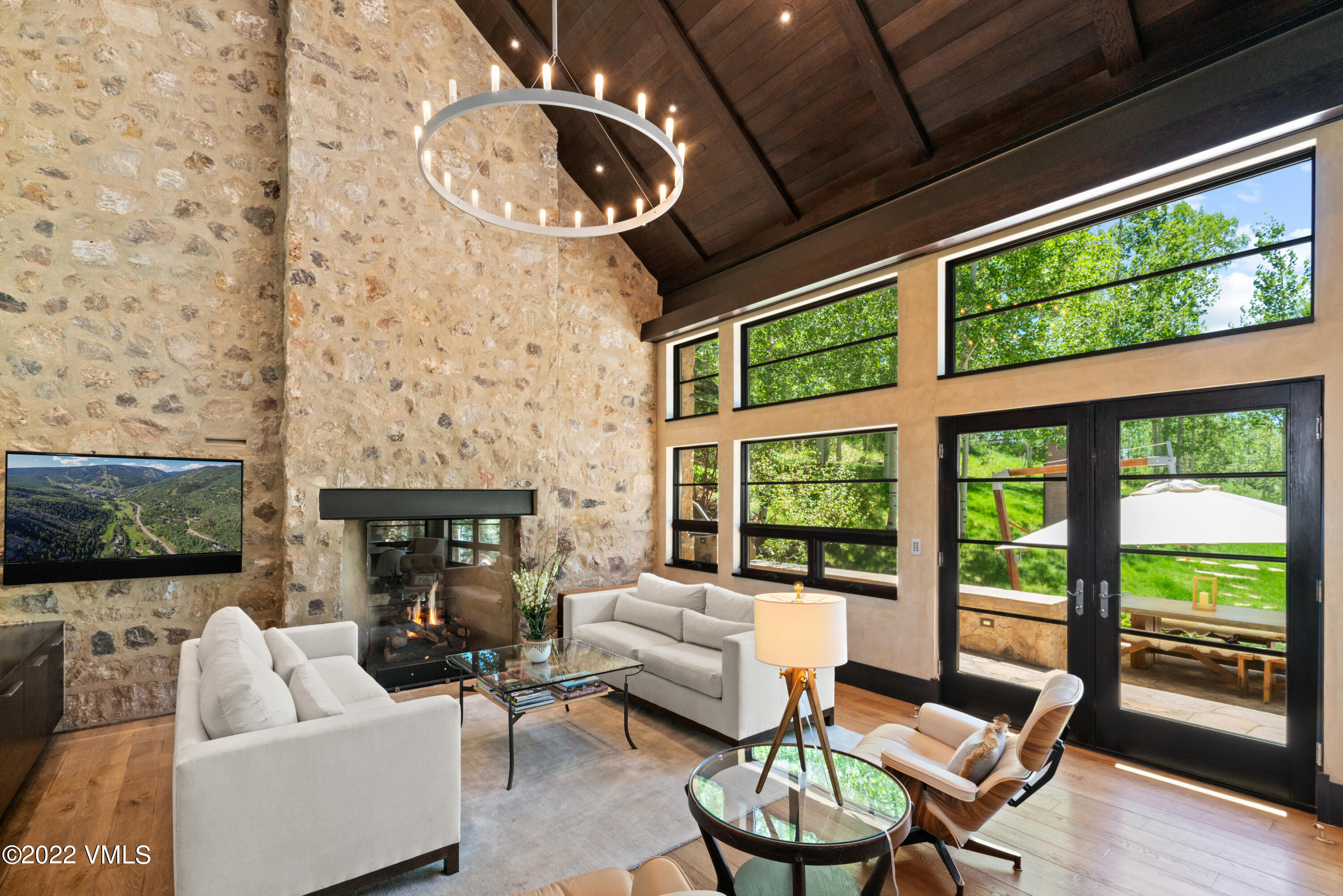 275 Wildrose Avon, CO 81620 - Photo 11 of 44 a living room with fireplace furniture and a floor to ceiling window