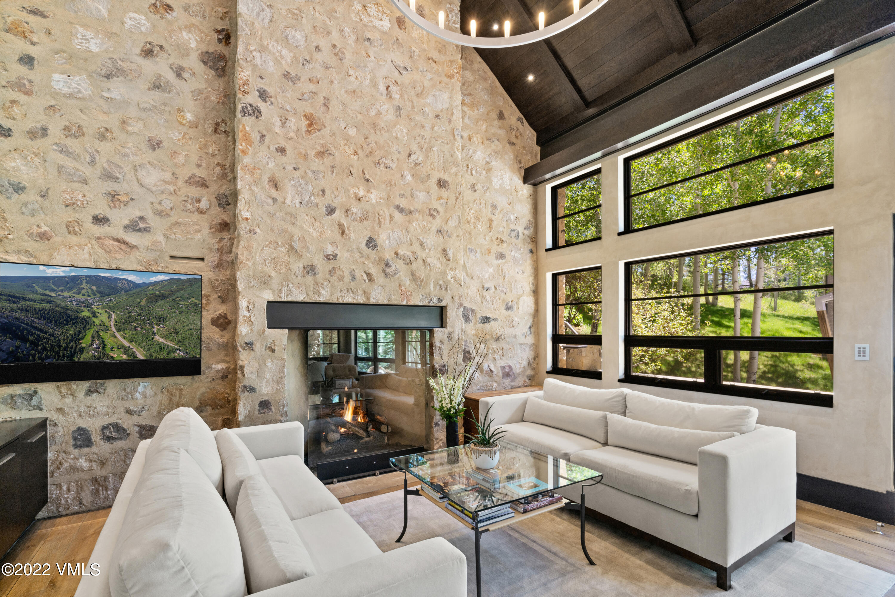 275 Wildrose Avon, CO 81620 - Photo 13 of 44 a living room with fireplace furniture and a flat screen tv