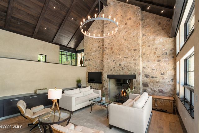 a living room with furniture a fireplace and a table