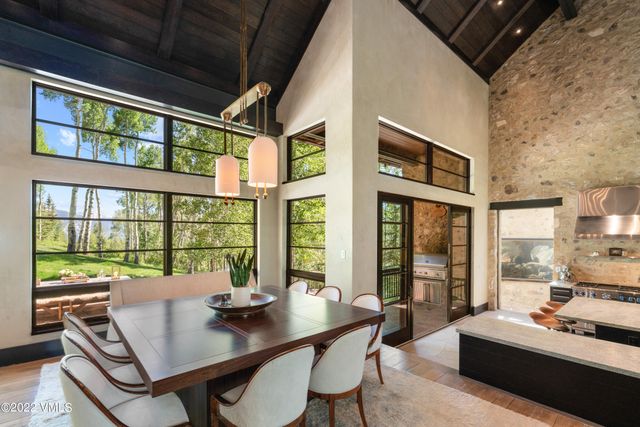 a view of a dining room with furniture large windows and wooden floor