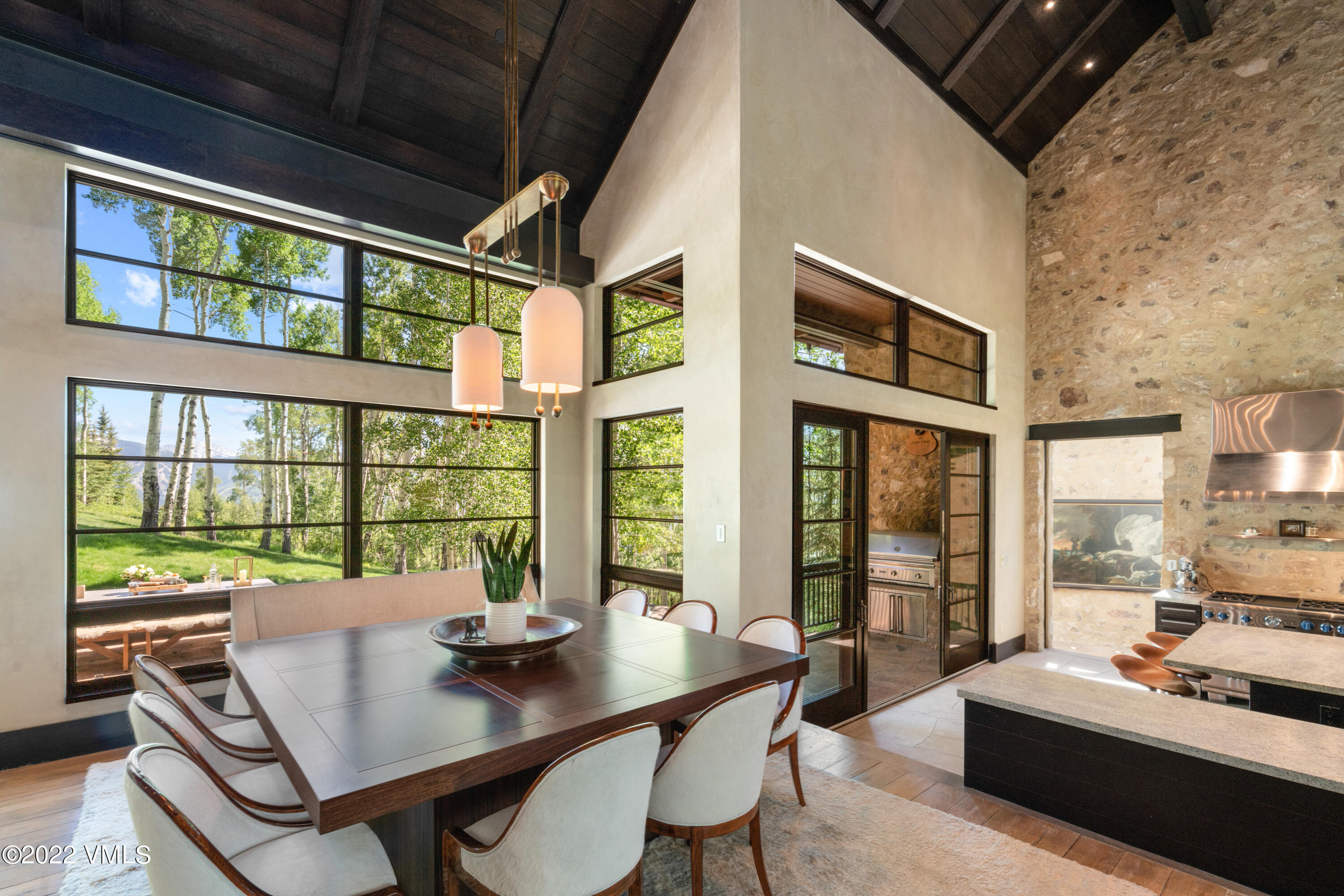 275 Wildrose Avon, CO 81620 - Photo 17 of 44 a view of a dining room with furniture large windows and wooden floor