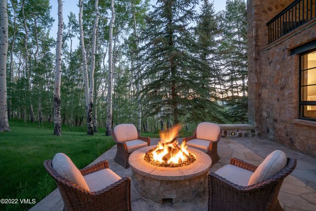 a backyard of a house with a fountain table and chairs