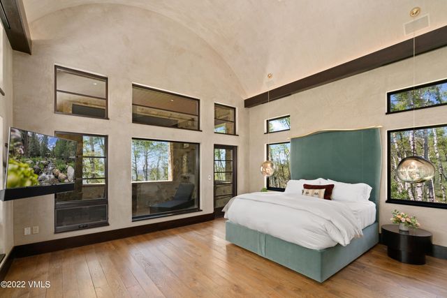 a bedroom with a large bed and a window