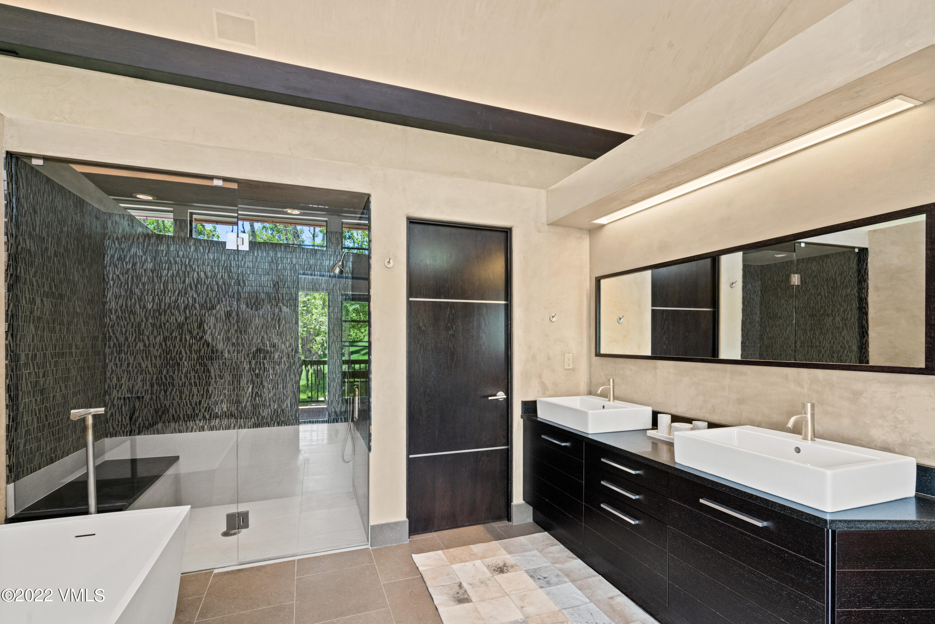 275 Wildrose Avon, CO 81620 - Photo 29 of 44 a bathroom with a tub sink and mirror