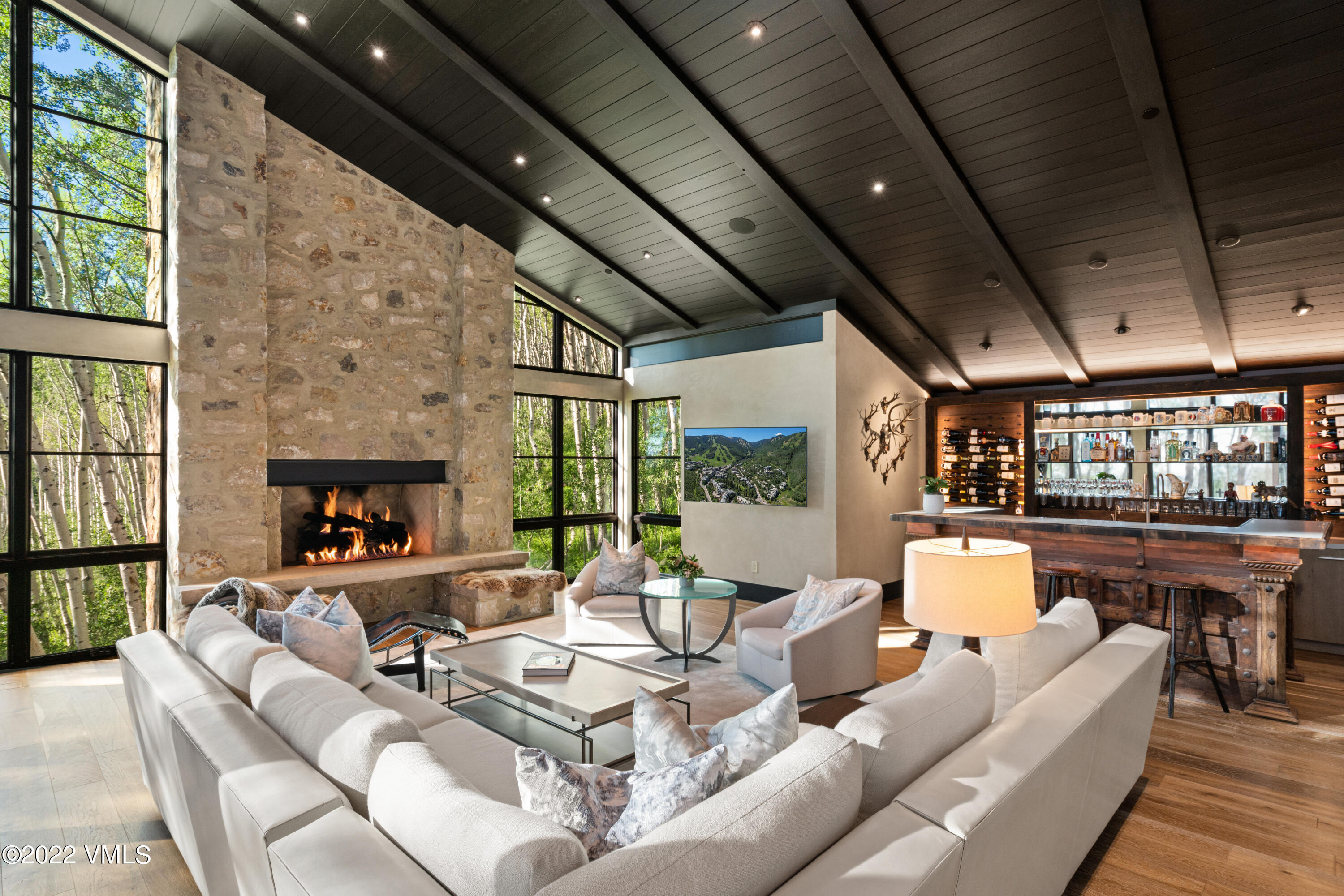 275 Wildrose Avon, CO 81620 - Photo 3 of 44 a living room with fireplace furniture and a floor to ceiling window