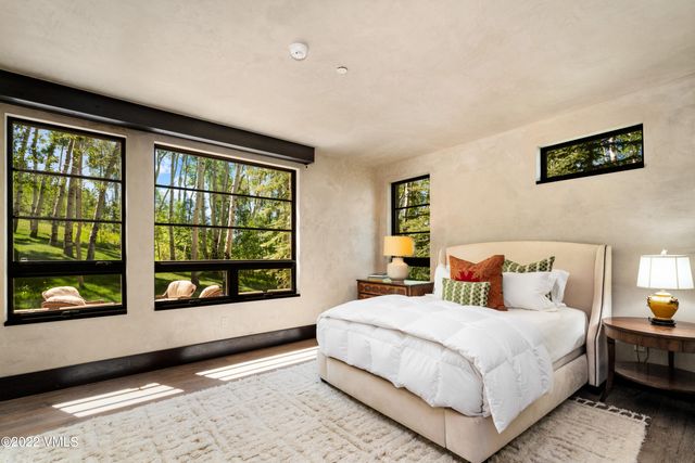 a bedroom with a large bed and a large window