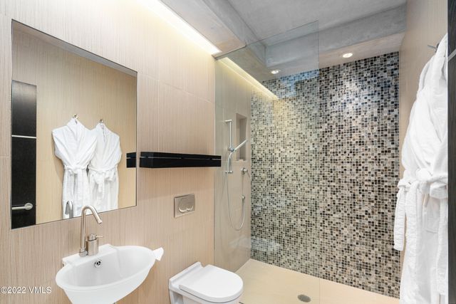 a bathroom with a sink toilet and shower