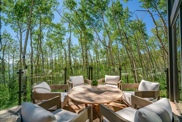 a backyard of a house with table and chairs
