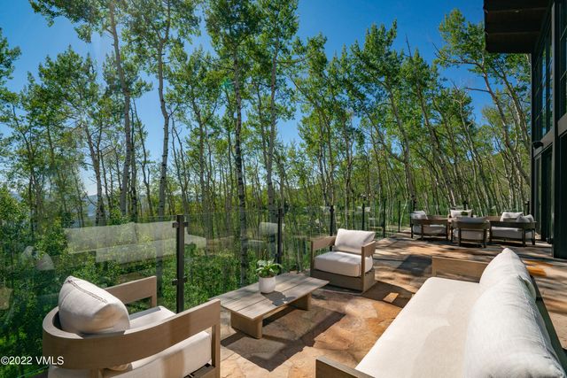 a view of a patio with couches chairs and a fire pit