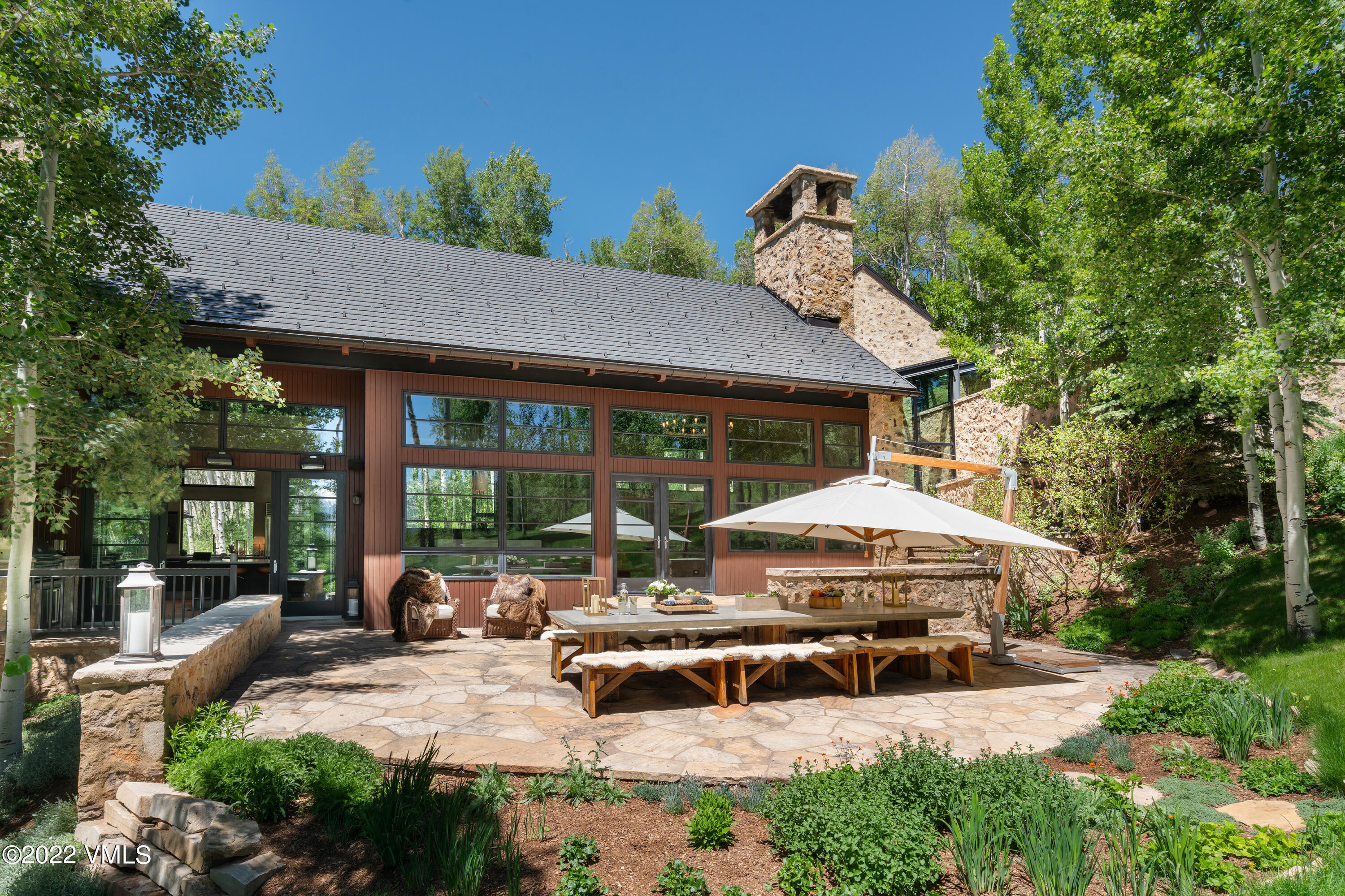 275 Wildrose Avon, CO 81620 - Photo 10 of 44 a view of a patio with table and chairs under an umbrella
