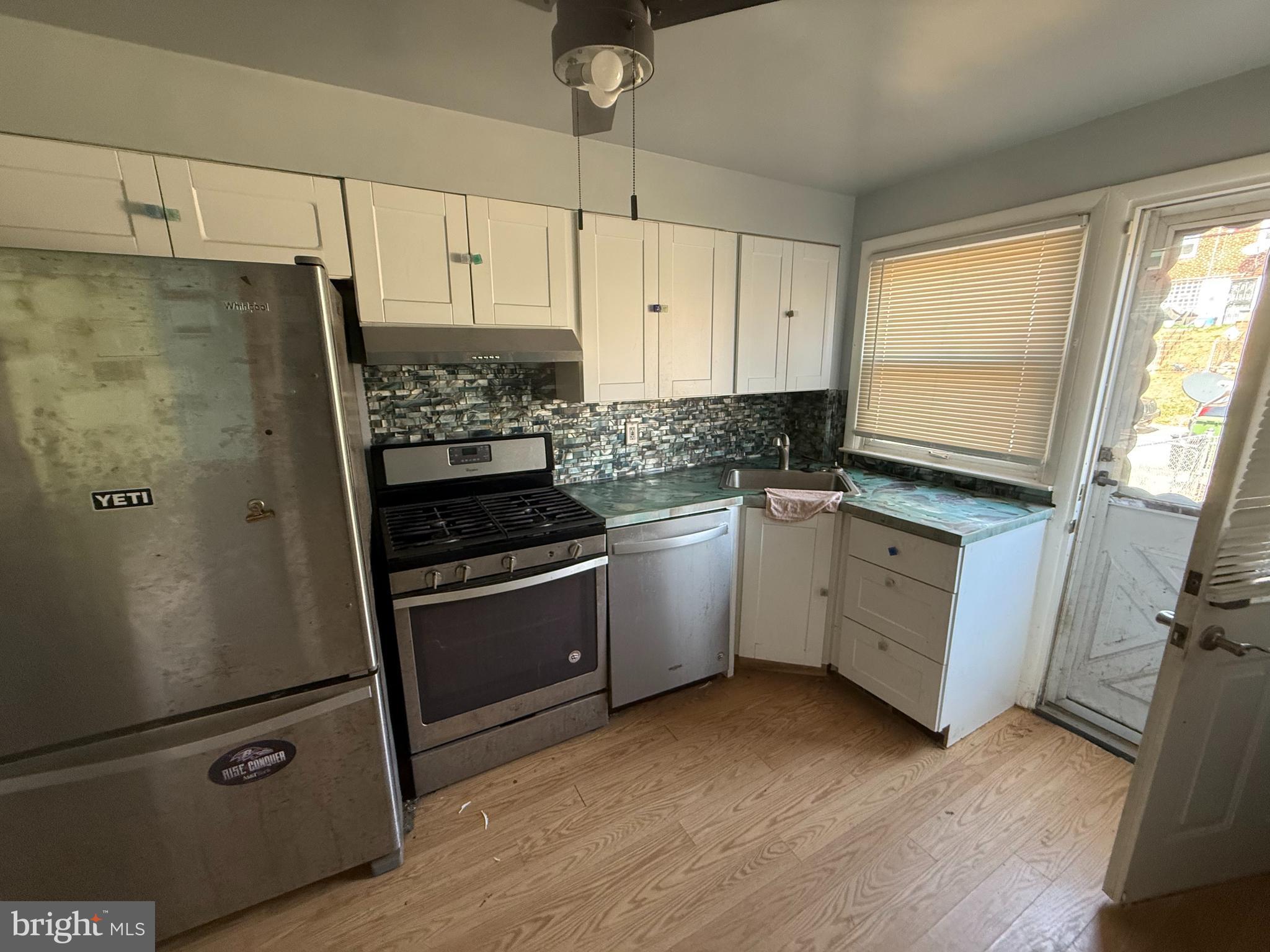 830 Reverdy Road Baltimore, MD 21212 - Photo 3 of 9 a kitchen with white cabinets and white appliances
