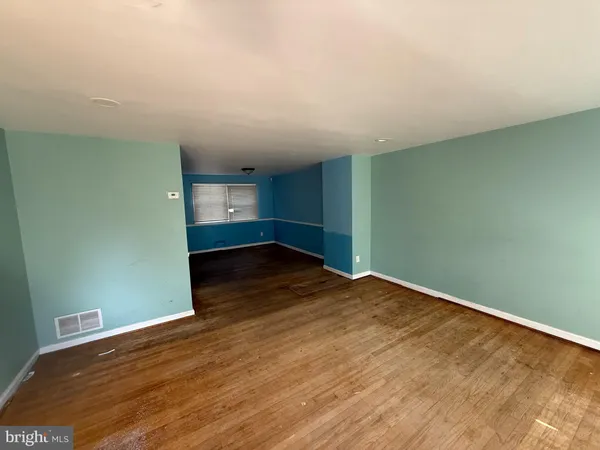 an empty room with wooden floor