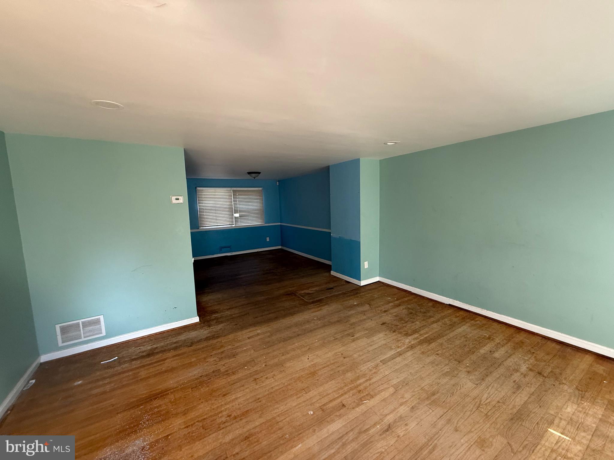 830 Reverdy Road Baltimore, MD 21212 - Photo 4 of 9 an empty room with wooden floor