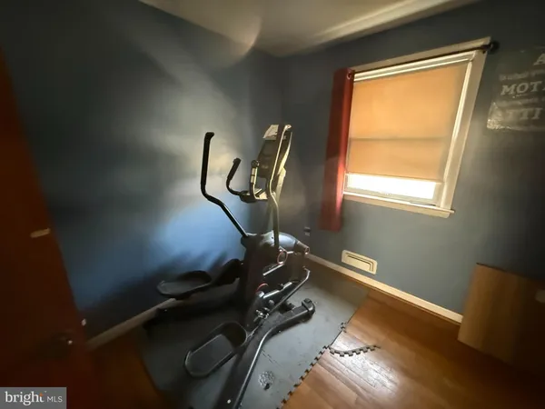 a room with gym equipment and a window