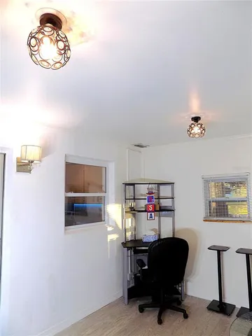 a view of a workspace with furniture and a window