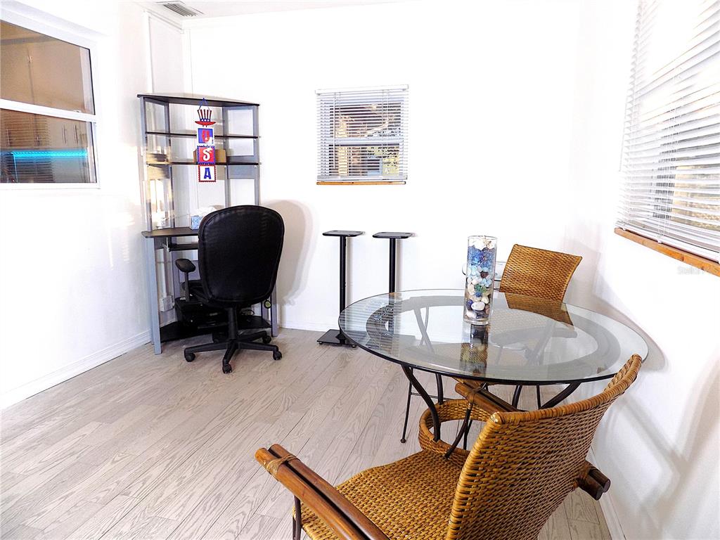 7344 Como Drive New Port Richey, FL 34655 - Photo 15 of 34 a work room with furniture and wooden floor