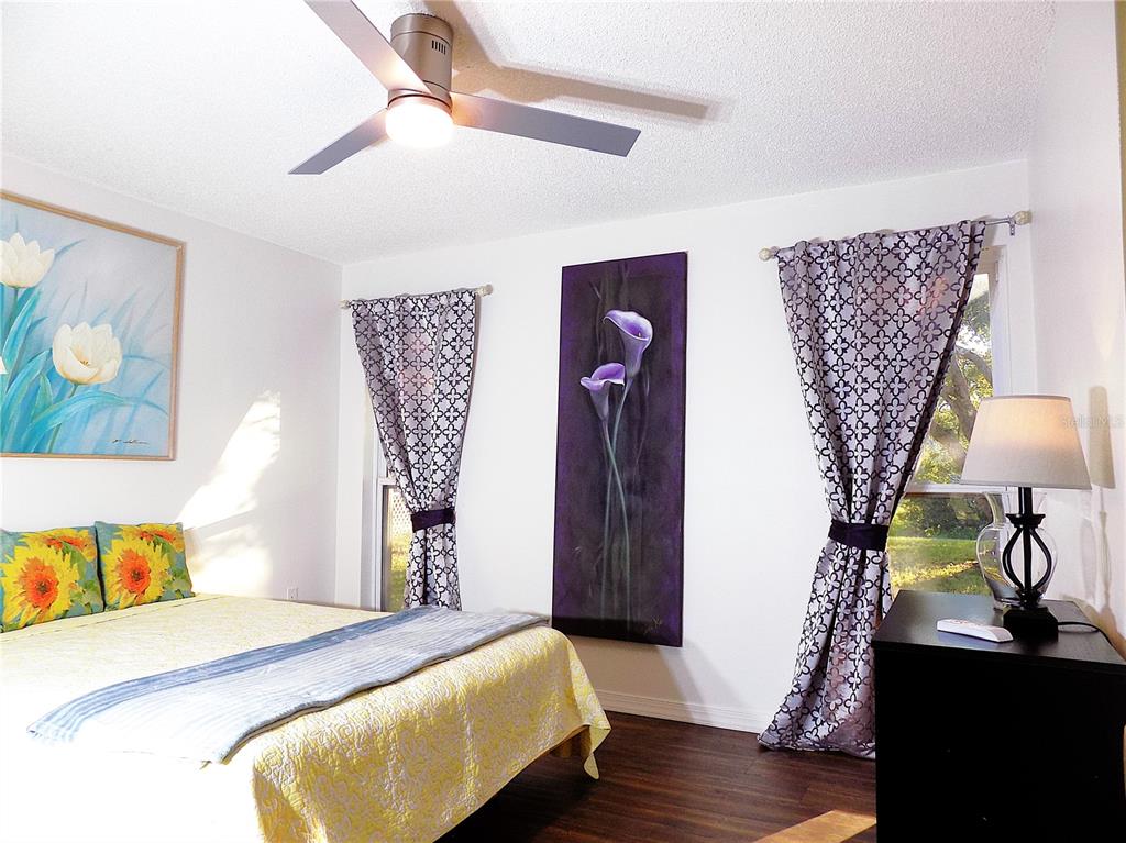 7344 Como Drive New Port Richey, FL 34655 - Photo 19 of 34 a bedroom with a bed and a lamp on dresser