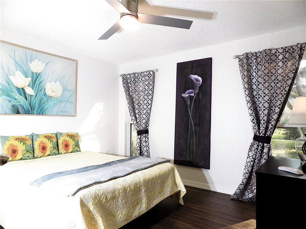 7344 Como Drive New Port Richey, FL 34655 - Photo 20 of 34 a bedroom with a bed and wooden floor