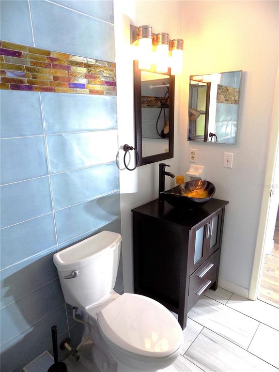 7344 Como Drive New Port Richey, FL 34655 - Photo 21 of 34 a bathroom with a toilet a sink and mirror