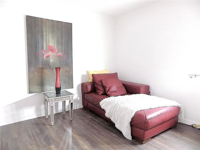 a bedroom with a bed and a potted plant