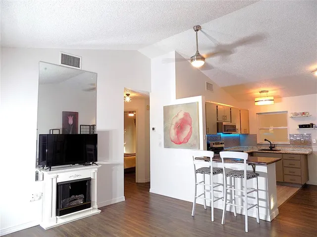 a view of a livingroom with furniture and a flat screen tv