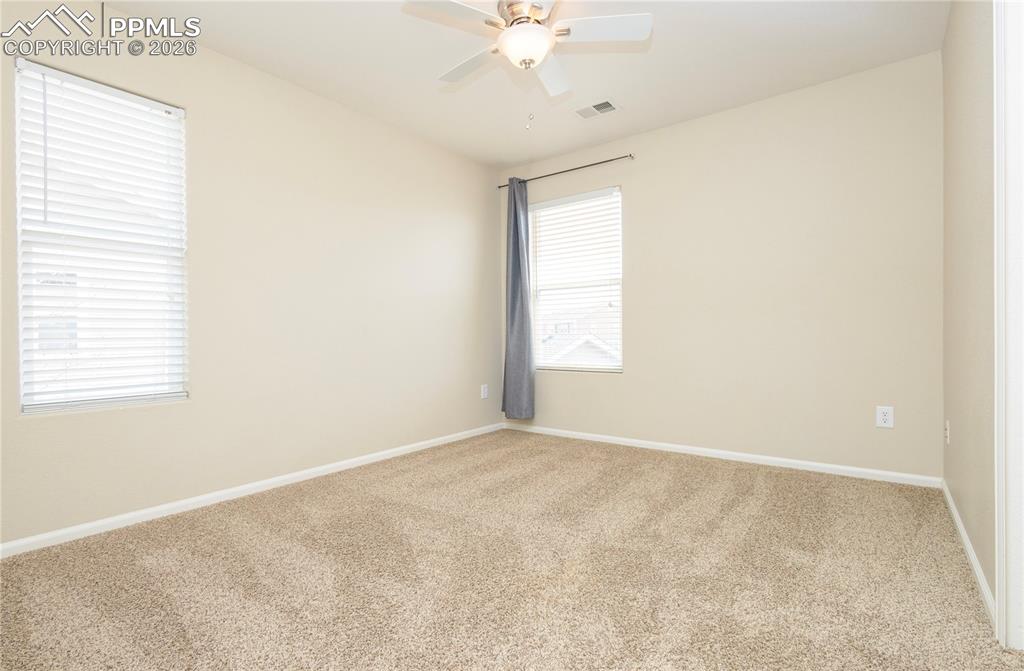 4815 Harrier Ridge Drive Colorado Springs, CO 80916 - Photo 22 of 33 Carpeted empty room with baseboards and a ceiling fan