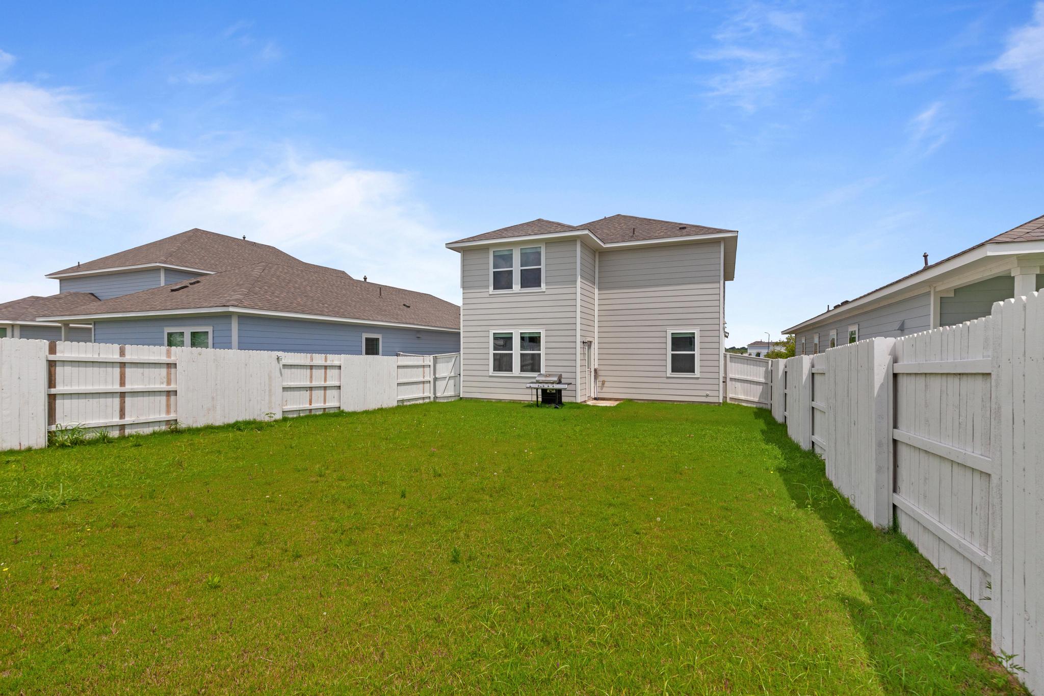 242 Barley Lane Elgin, TX 78621 - Photo 31 of 31 Expansive green lawn providing ample outdoor space