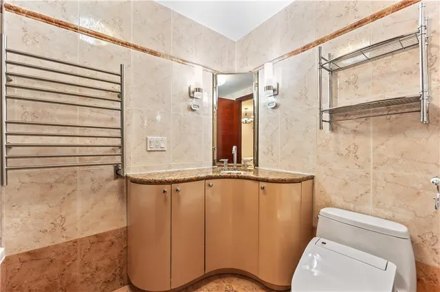 a bathroom with a sink and mirror with bathtub