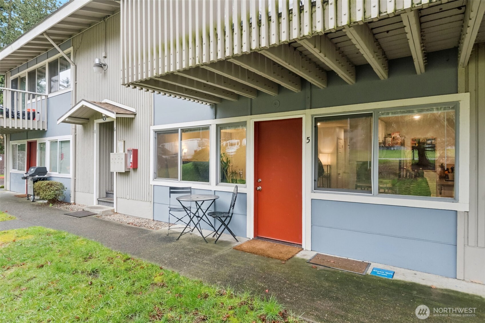 9623 South 248th Street, Unit G5 Kent, WA 98030 - Photo 22 of 23 a view of a chair and table in backyard of the house