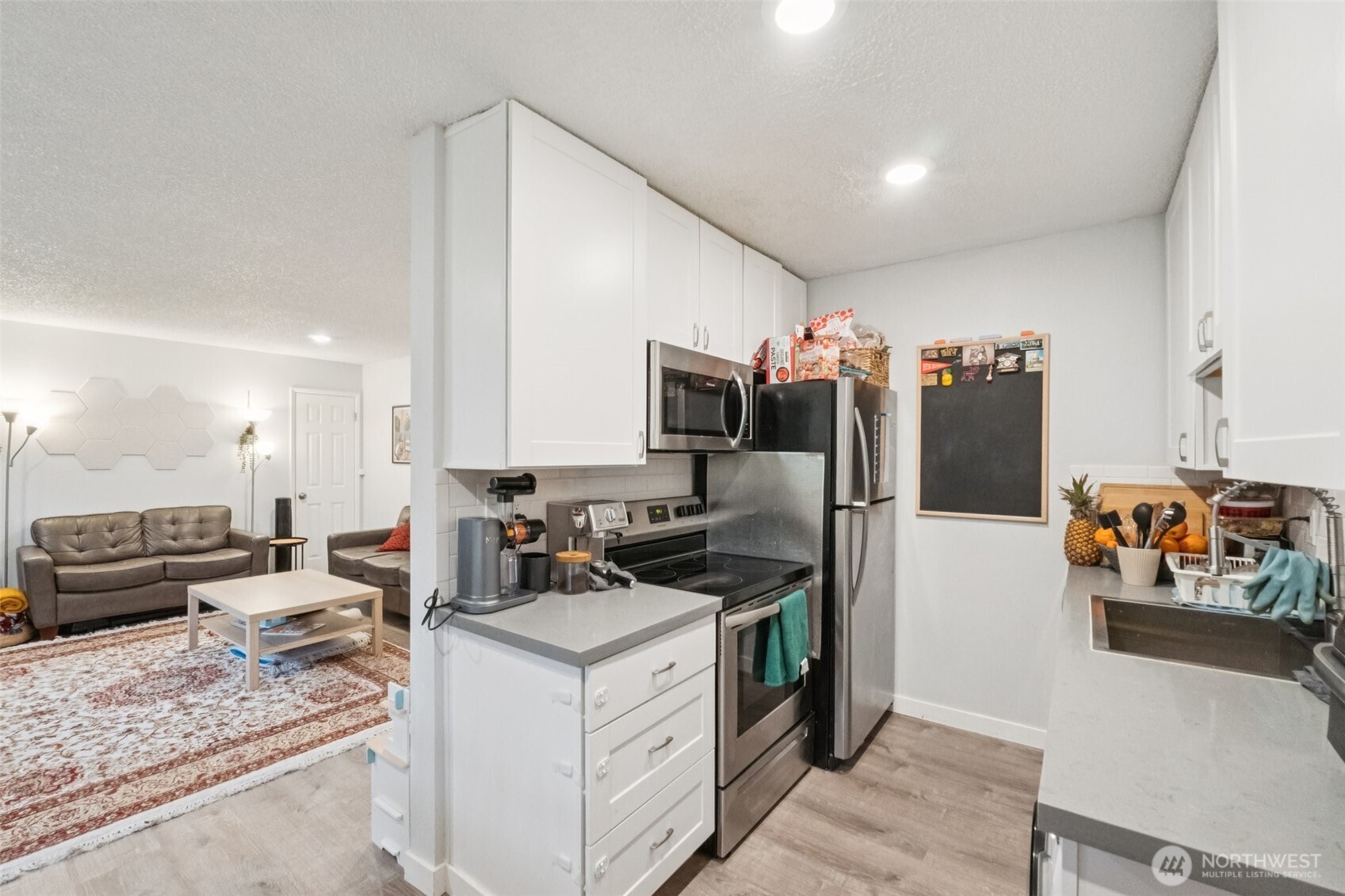 9623 South 248th Street, Unit G5 Kent, WA 98030 - Photo 10 of 23 a kitchen that has a lot of cabinets a sink and a refrigerator