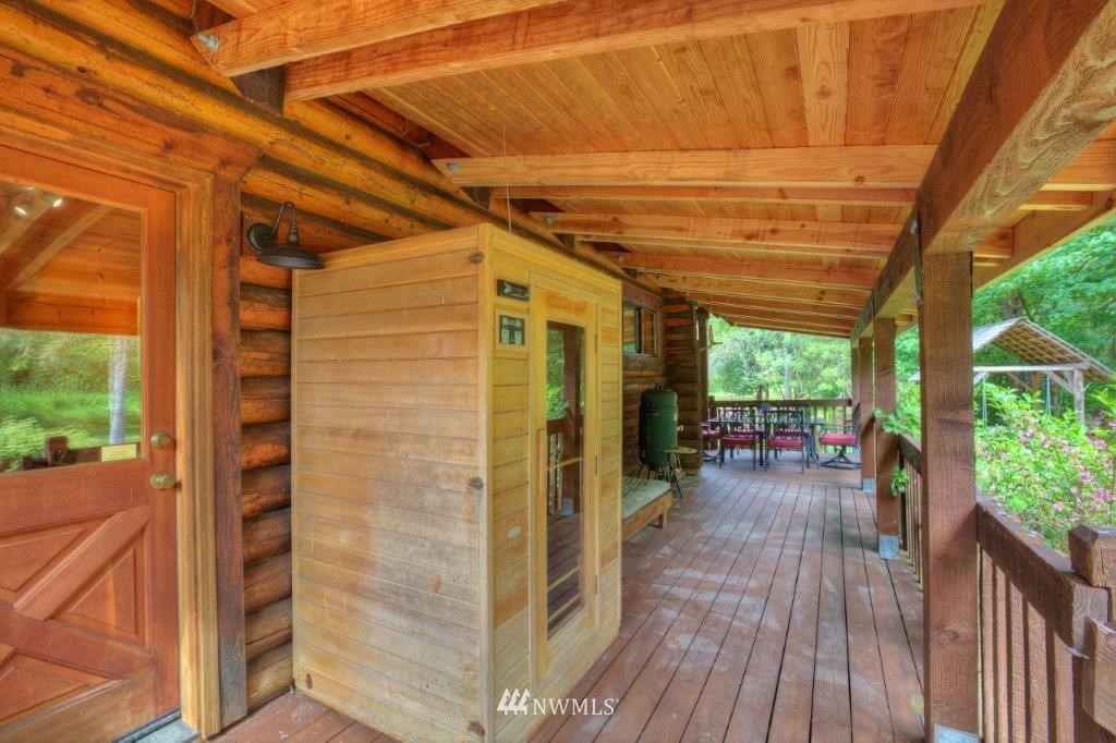 24107 Brooks Road East Orting, WA 98360 - Photo 22 of 40 a view of a patio with wooden floor and roof with a view of the house
