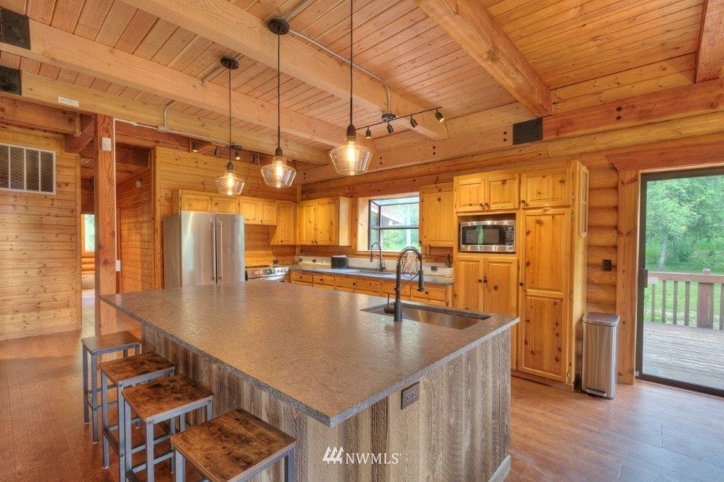 24107 Brooks Road East Orting, WA 98360 - Photo 5 of 40 a kitchen with stainless steel appliances granite countertop a sink a counter space and cabinets
