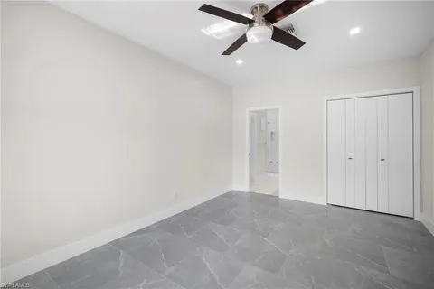 a bathroom with a granite countertop sink a toilet and shower