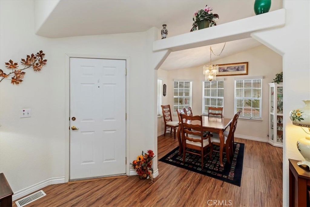 27250 Murrieta Road, Unit 298 Menifee, CA 92586 - Photo 11 of 54 a view of a dining room with furniture and wooden floor