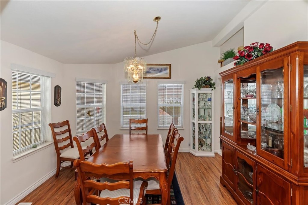 27250 Murrieta Road, Unit 298 Menifee, CA 92586 - Photo 15 of 54 a view of a dining room with furniture window and wooden floor