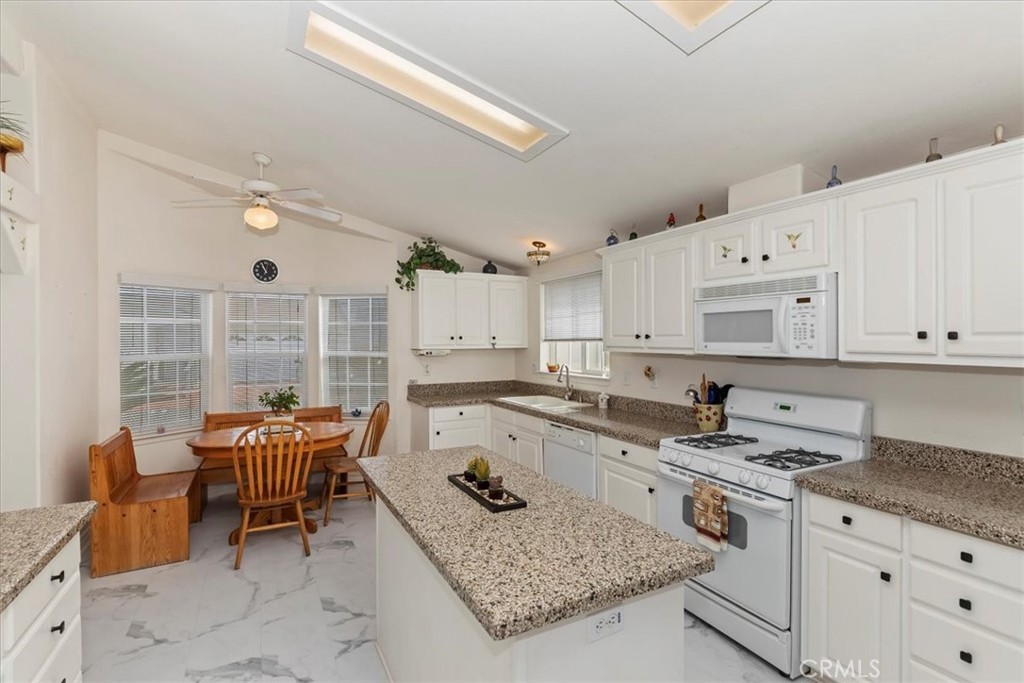 27250 Murrieta Road, Unit 298 Menifee, CA 92586 - Photo 18 of 54 a kitchen with a stove a sink and a refrigerator
