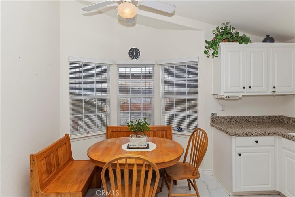 27250 Murrieta Road, Unit 298 Menifee, CA 92586 - Photo 19 of 54 a view of a dining room with furniture and wooden floor