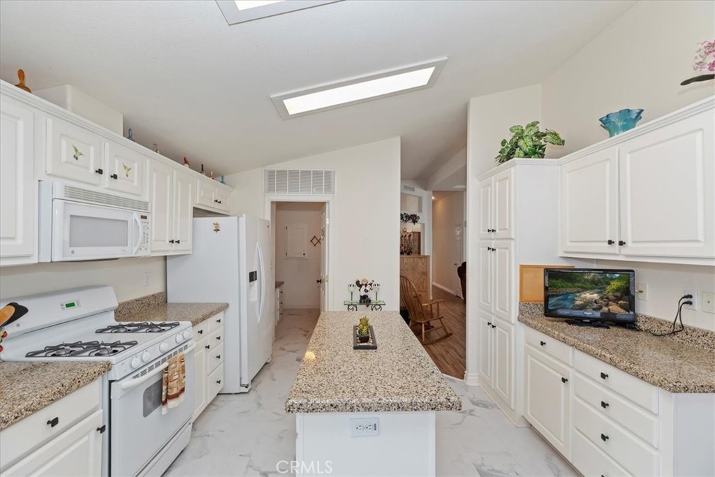 27250 Murrieta Road, Unit 298 Menifee, CA 92586 - Photo 20 of 54 a kitchen with stainless steel appliances granite countertop a stove and a refrigerator