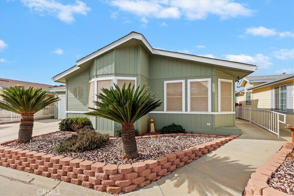 27250 Murrieta Road, Unit 298 Menifee, CA 92586 - Photo 2 of 54 a front view of a house with garden