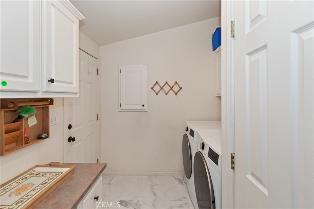 27250 Murrieta Road, Unit 298 Menifee, CA 92586 - Photo 23 of 54 a bathroom with a granite countertop sink a washer and dryer