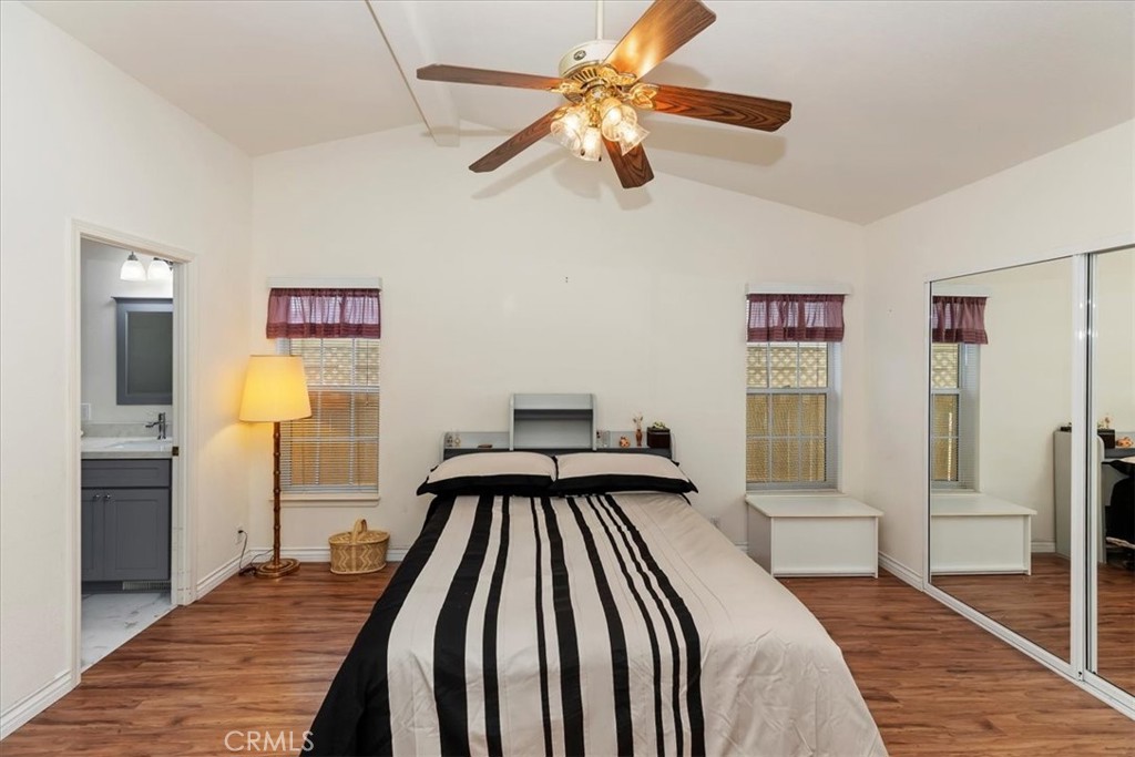 27250 Murrieta Road, Unit 298 Menifee, CA 92586 - Photo 24 of 54 a bedroom with a bed and a chandelier