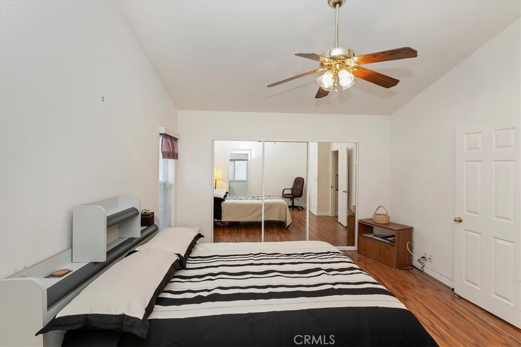 27250 Murrieta Road, Unit 298 Menifee, CA 92586 - Photo 25 of 54 a bedroom with a bed and a chandelier