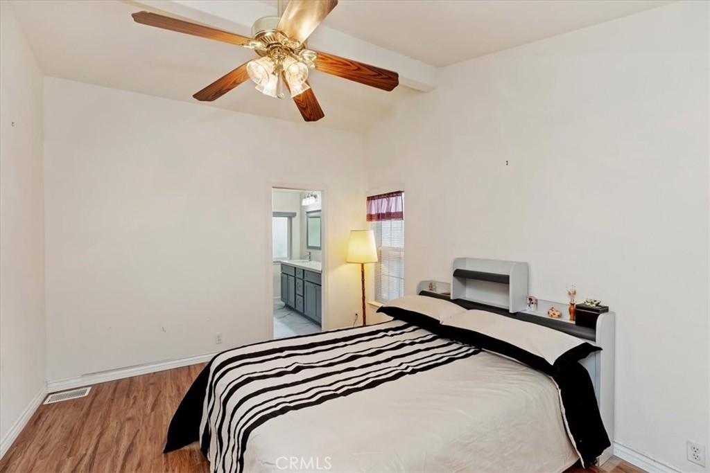 27250 Murrieta Road, Unit 298 Menifee, CA 92586 - Photo 26 of 54 a bedroom with a bed and a ceiling fan