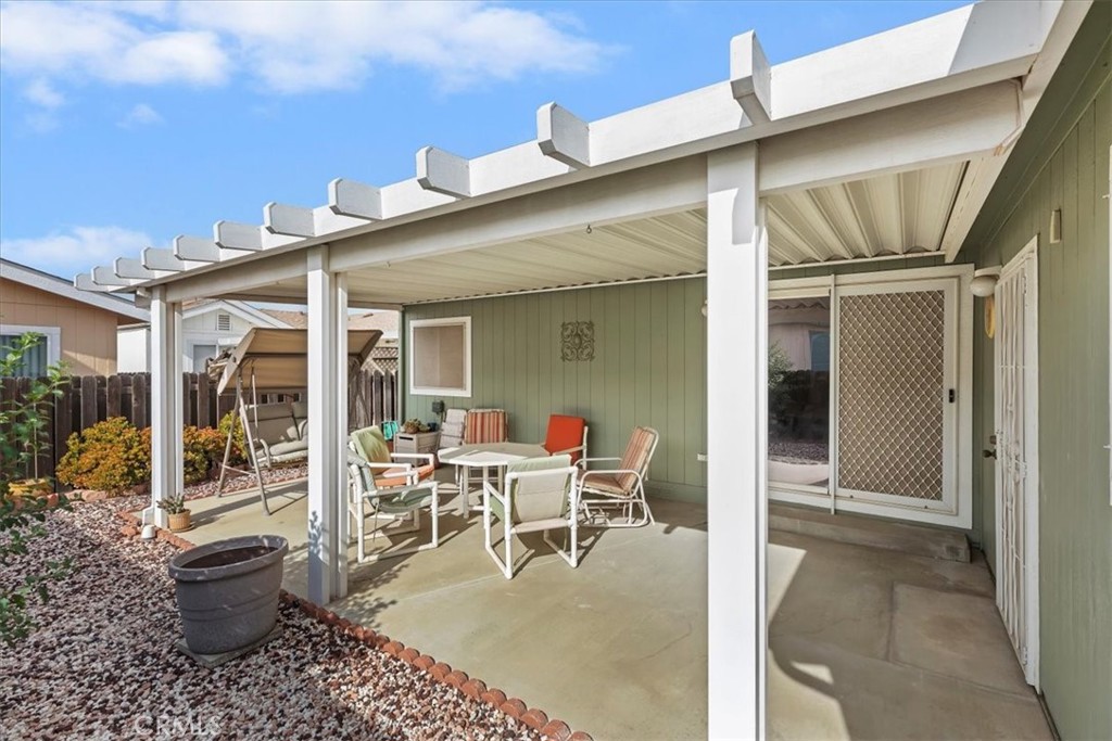 27250 Murrieta Road, Unit 298 Menifee, CA 92586 - Photo 36 of 54 a view of a patio with table and chairs and potted plants