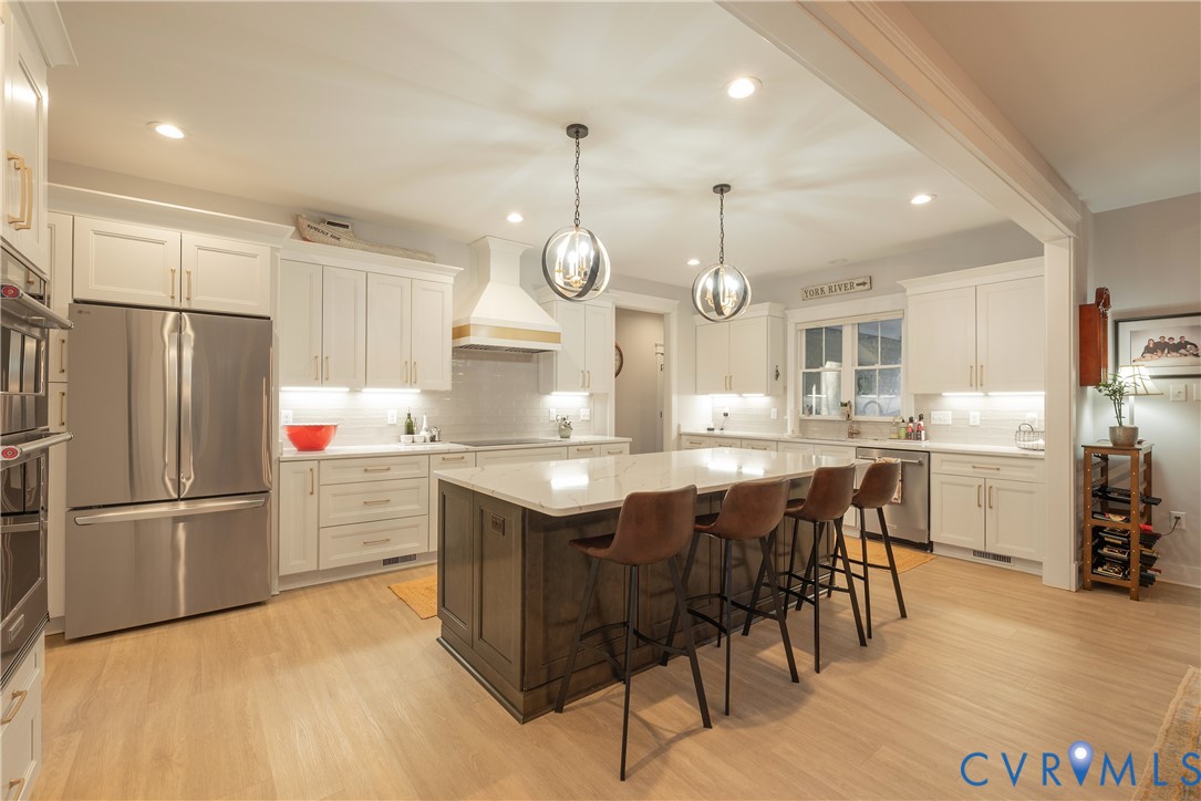 2591 Shaughnessy Road Powhatan, VA 23139 - Photo 21 of 50 a kitchen with cabinets a refrigerator and chairs