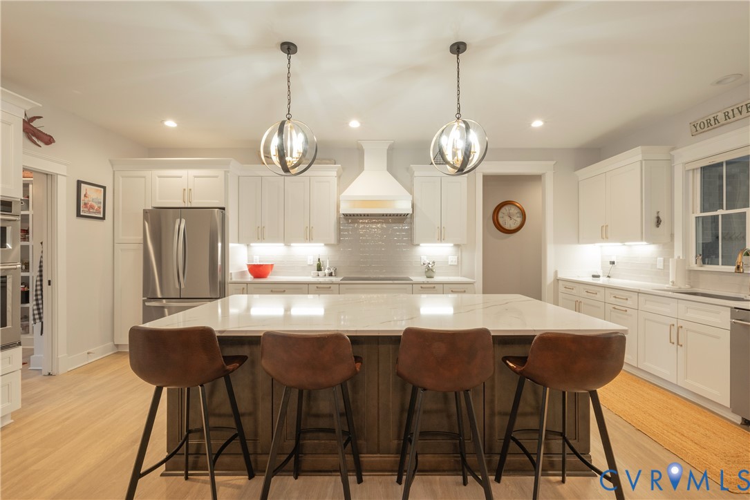 2591 Shaughnessy Road Powhatan, VA 23139 - Photo 25 of 50 a kitchen with stainless steel appliances kitchen island granite countertop a dining table chairs and white cabinets