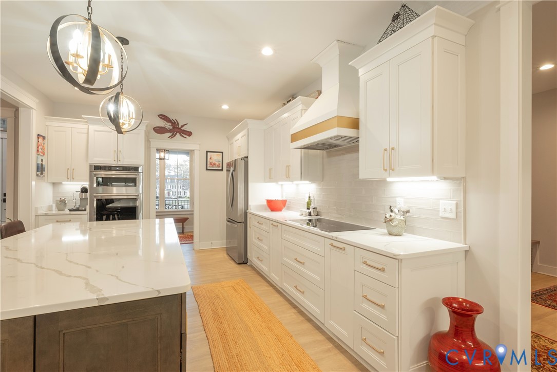 2591 Shaughnessy Road Powhatan, VA 23139 - Photo 26 of 50 a large white kitchen with a large window a sink and stainless steel appliances