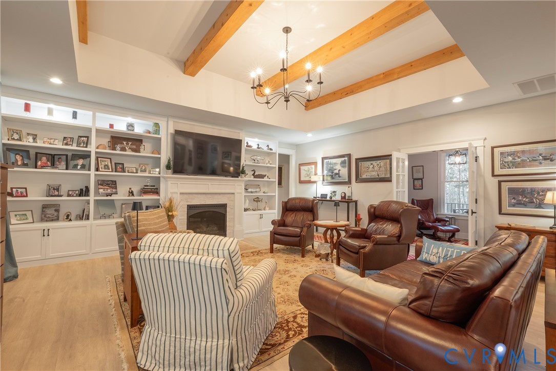 2591 Shaughnessy Road Powhatan, VA 23139 - Photo 31 of 50 a living room with furniture a fireplace and a flat screen tv