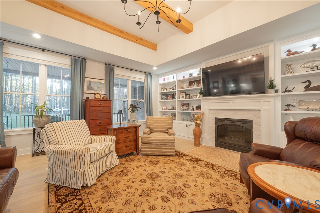 2591 Shaughnessy Road Powhatan, VA 23139 - Photo 33 of 50 a living room with furniture a flat screen tv and a fireplace